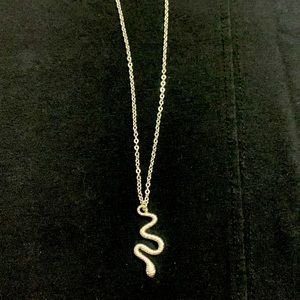 Silver tone necklace with snake pendant. 18 in. Chain with lobster claw clasp.